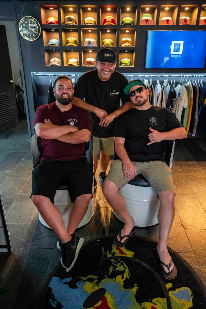 Calibis Farms founders — Tomas, AJ and Lenny — standing on their California cannabis farm